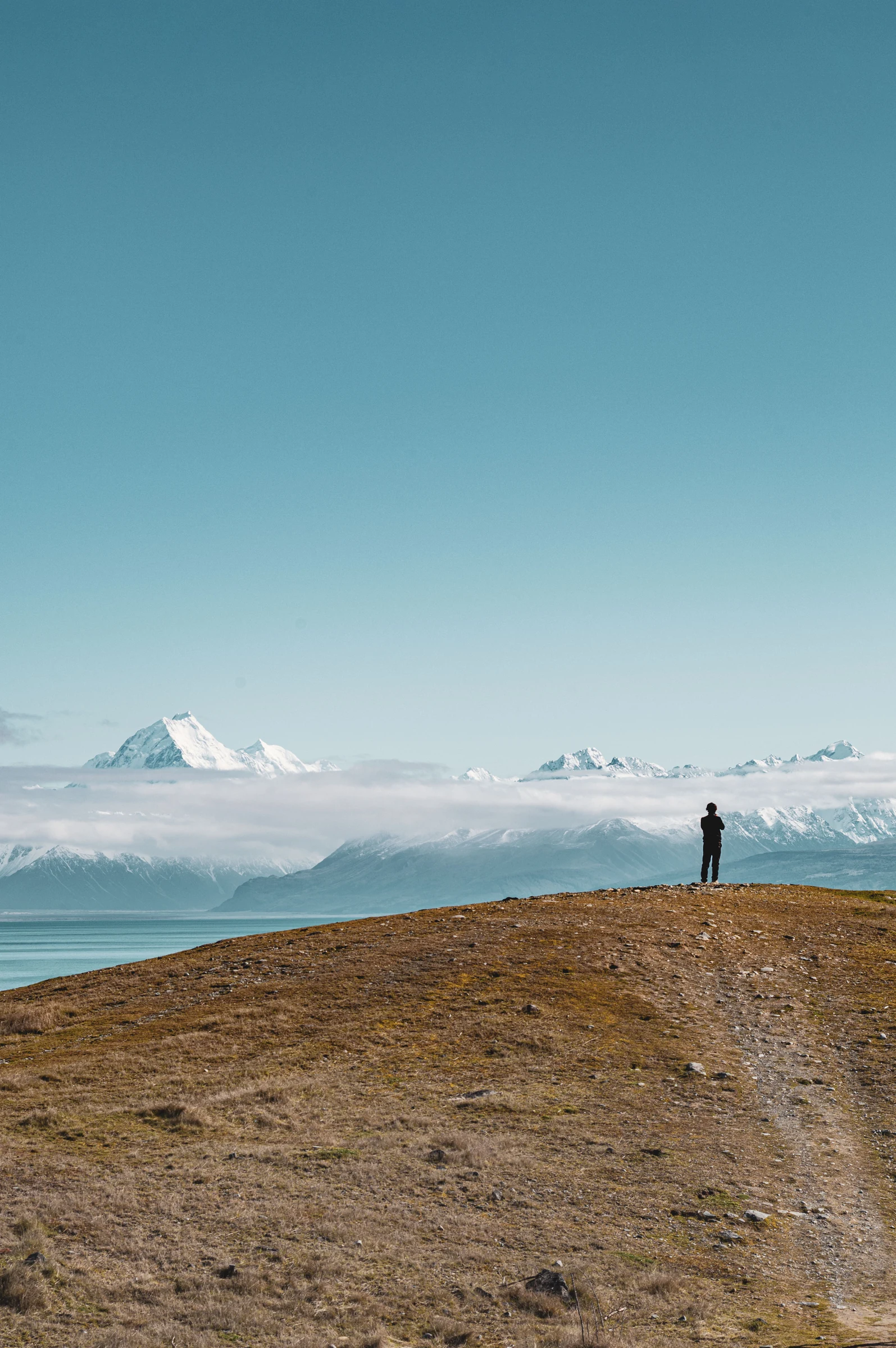 A traveller looking across the Southern Alps and lake