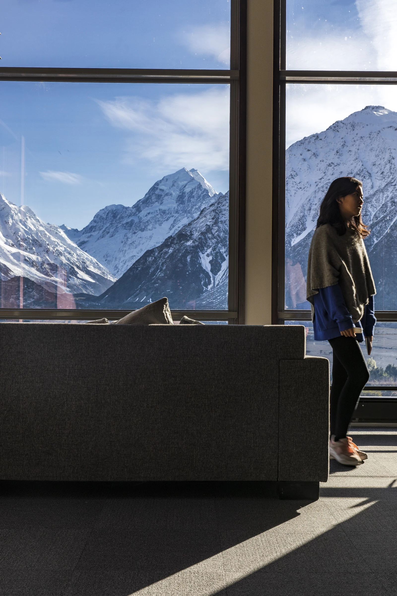 A traveller looking towards Mount Cook from a window